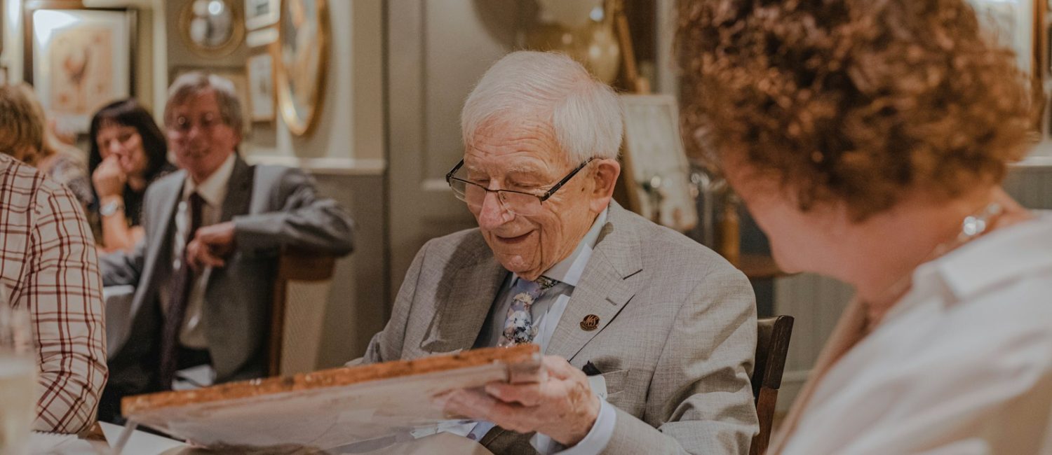 smiling man holding box